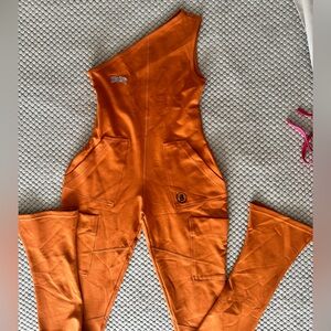 Body by Raven Tracy CAMP 1 PIECE CARGO
JUMPSUIT (BURNT ORANGE) size M